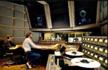 two men sitting in a recording studio