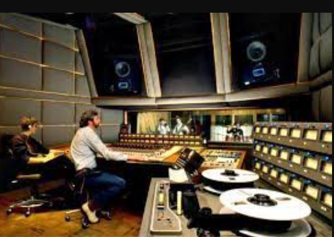 two men sitting in a recording studio