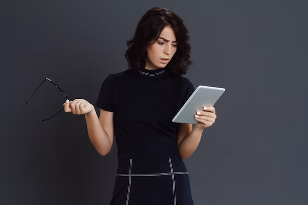 The girl holds an iPad in her hands and expresses her emotions