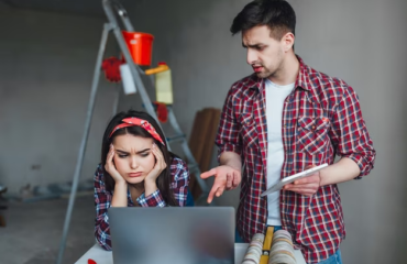 The guy and the girl express dissatisfaction looking at a laptop